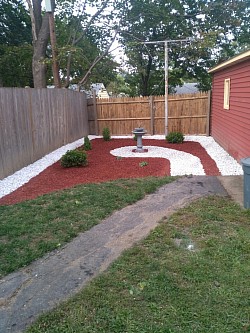 The client wanted to have a low maintenance Back yard that they can enjoy,  white Marble stone and red mulch with shrubs planted. (Albany NY)